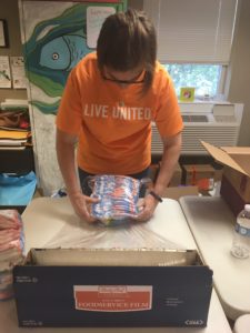 MEM employee Julie packages diapers for First Chance for Children