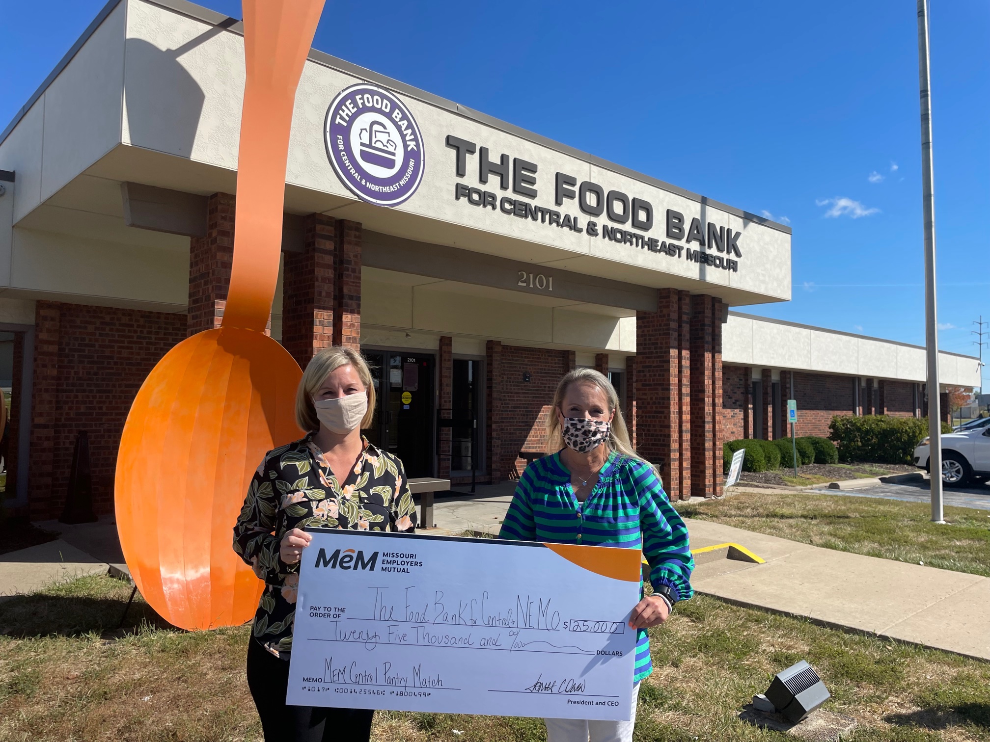 Jennifer Peck presents check to the Food Bank