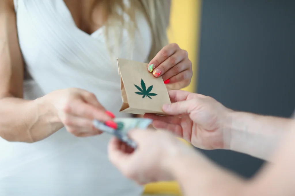 A woman in a white dress gives money and receives a bag of marijuana. Courier delivers the order of pharmacy cannabis
