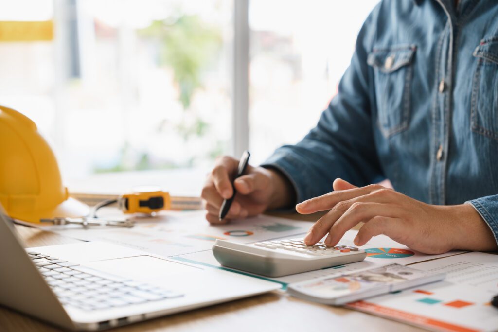 Businessmen are planning budgets for construction projects, analyzing company financial statements, managing global construction project costs.