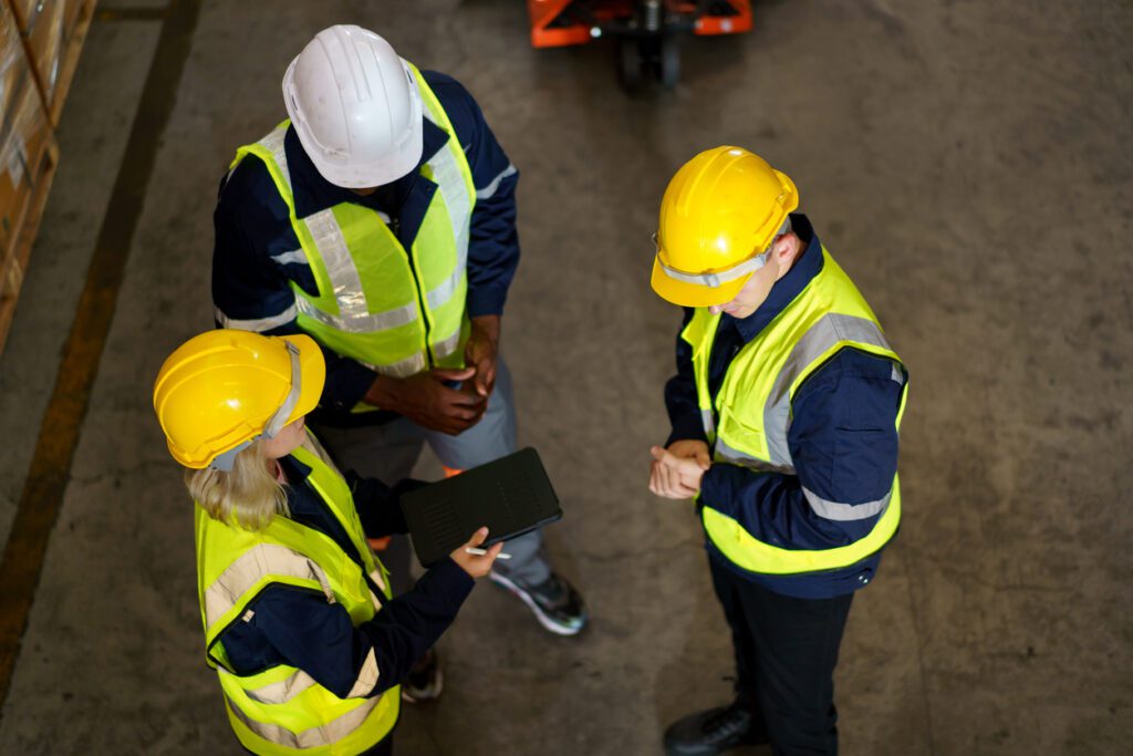 Diversity ethnicity of warehouse staff or engineer making a discussion together before start working, team of engineer in factory making a morning brief before working.
