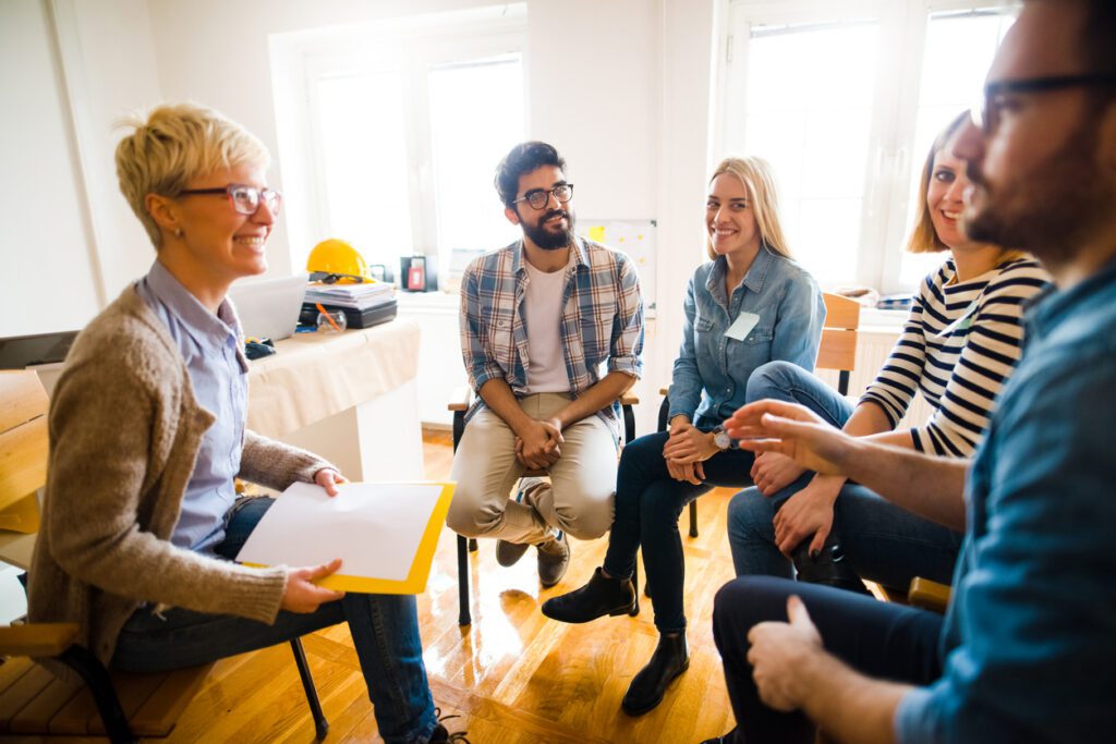 Group of people sitting in a circle at safety training