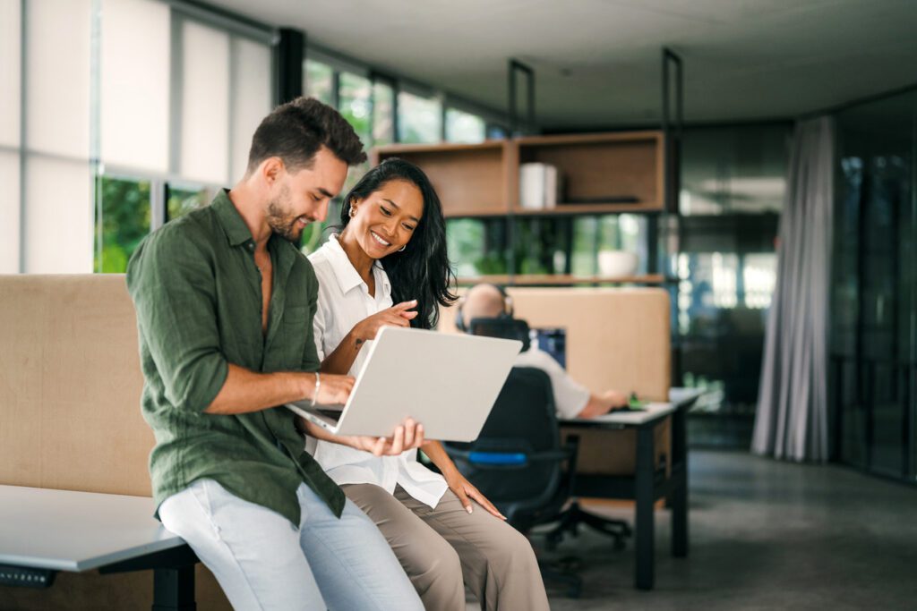 Multicultural professional businesspeople working together on research plan in boardroom.