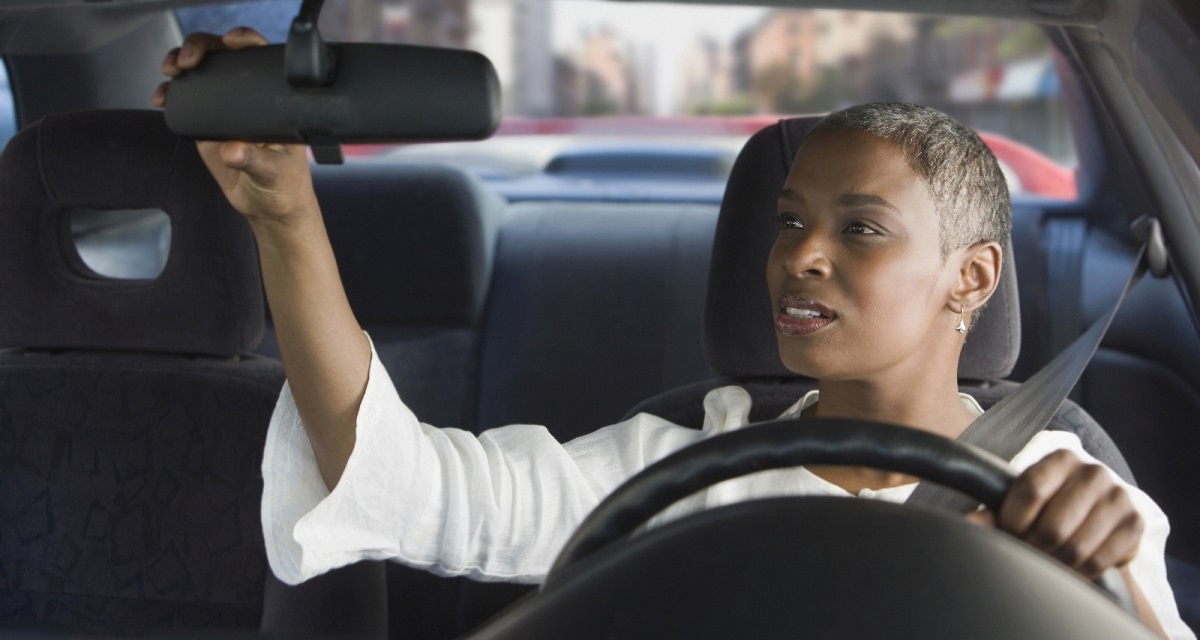 Driver checks rearview mirror